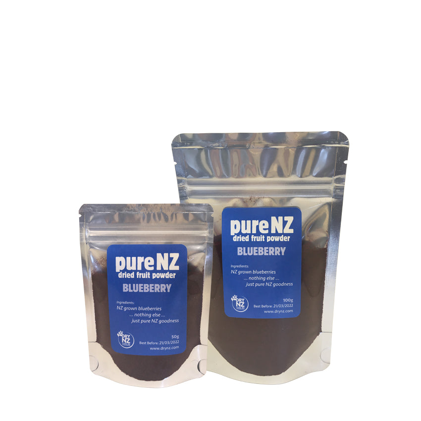 Two pouches of pureNZ blueberry powder, one larger and one smaller, with labels indicating the product name and the fact that it is a 100% blueberry powder.
