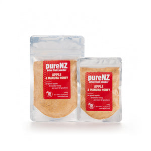 Two sealed bags of PureNZ Apple & Manuka Honey Powder, one larger and one smaller with red and white labeling.