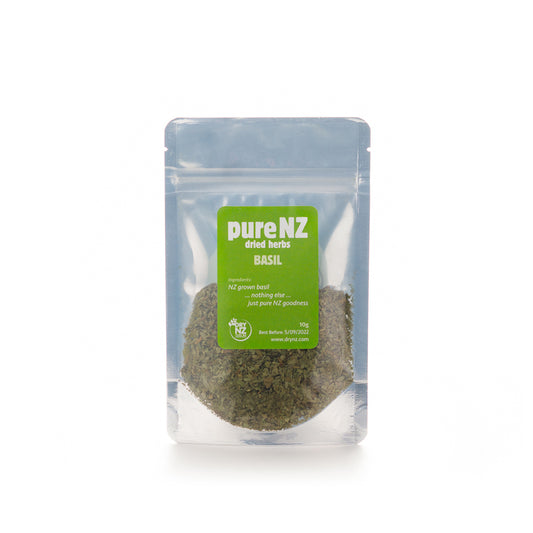 A sealed, clear plastic bag of Pure NZ Basil leaves, with a green label displaying the brand and product name.