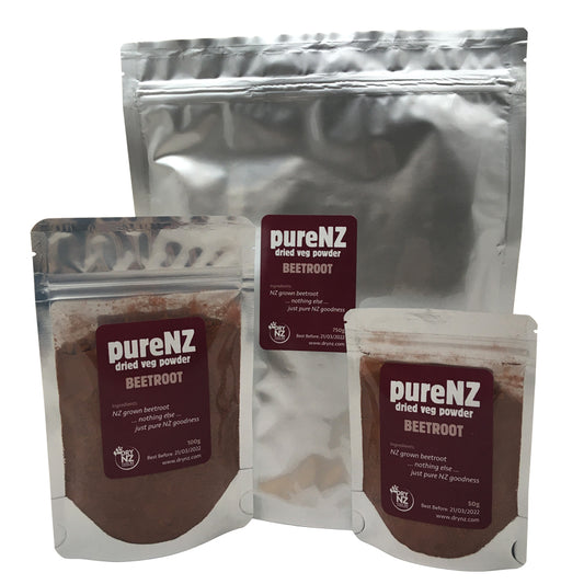Three bags of PureNZ beetroot powder, showing different sizes with labels indicating the product is 100% whole beetroot, sourced from NZ.