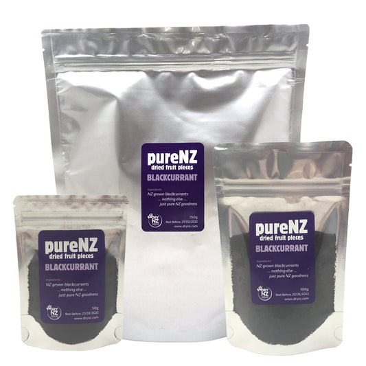 Three bags of PureNZ Blackcurrant pieces in different sizes, with branding and product information visible on the labels.