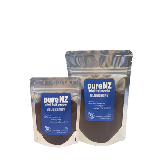 Two pouches of pureNZ blueberry powder, one larger and one smaller, with labels indicating the product name and the fact that it is a 100% blueberry powder.
