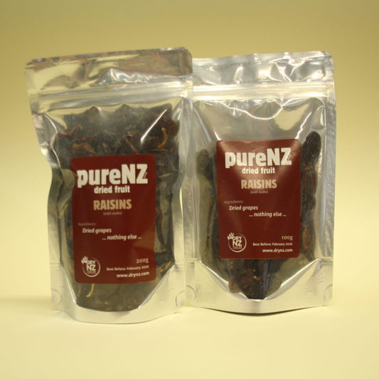 Two sealed bags of PureNZ dried grapes/raisins, one smaller and one larger, with labels indicating the product details on a white background.
